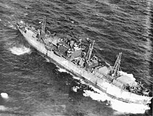 Aerial photograph of the Liberty ship SS John W. Brown outbound from the United States carrying a large deck cargo after her conversion to a "Limited Capacity Troopship." It probably was taken in the summer of 1943 during her second voyage. SS John W. Brown aerial photo.jpg