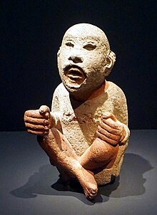 Teixiptla of Aztec deity Xipe Totec, shown wearing the flayed skin of a sacrificial victim Stone Statue of Xipe Totec (DSC08014b).jpg