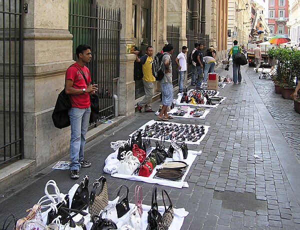 Street hawkers selling bags and sunglasses in central Rome, Italy