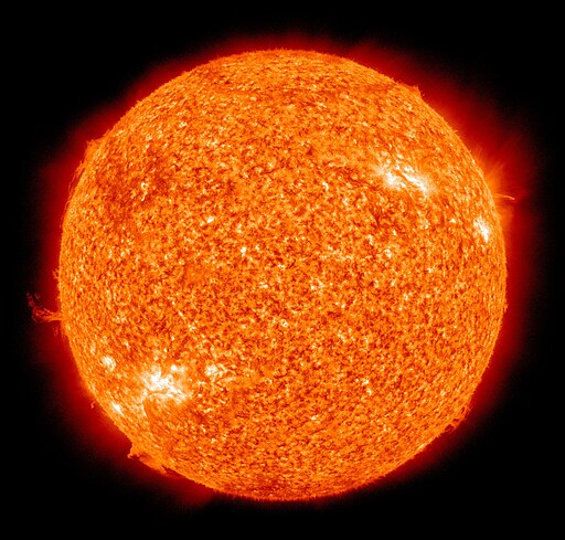 An image of our sun, a bright orange and red sphere glowing against a black background.