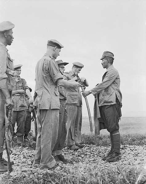 Major Wako Lisanori, Chief of the Japanese XXVIII Army, surrenders to Lieutenant Colonel O. N. Smyth of the 10th Gurkha Rifles.