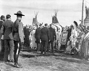 Their Majesties greet chieftains of the Stoney Indian Tribe, who have brought a photo of Queen Victoria.jpg