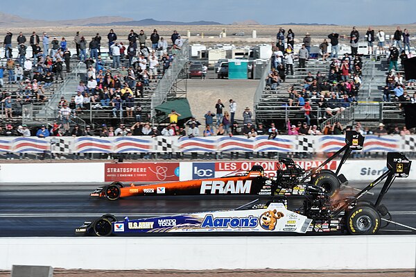 Two Top Fuel dragsters side by side during an NHRA event in 2012