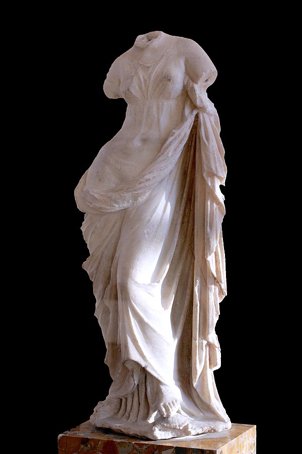 Aphrodite Ourania, draped rather than nude, with her foot resting on a tortoise (Louvre)