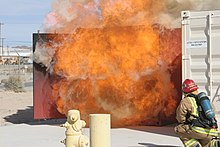 A firefighter demonstrates the behavior of a backdraft during live-fire training USMC-071117-M-1283D-084.jpg