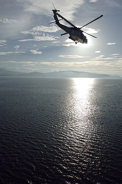 File:US Navy 080609-N-1450G-062 A MH-60S helicopter assigned to Helicopter Combat Squadron (HSC) 21, based out of San Diego, Calif., flies over Illana Bay, Philippines towards a Pacific Partnership medical civic action program.jpg