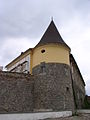 Partly reconstructed corner tower.