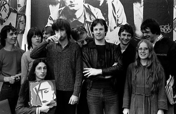 XTC photographed with Canadian fans, 1980. From left: Moulding (holding cup), Partridge (in the background, wearing glasses), Gregory, and Chambers.