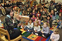 Joanne Sharp, wife of Gen. Walter Sharp, United States Forces Korea commanding general, visits the U.S. Army's Yongsan Garrison Library on 21 Nov. 2009 to read to military family members as part of a Thanksgiving Story Hour. U.S. Army photo Yongsan Army Library.jpg