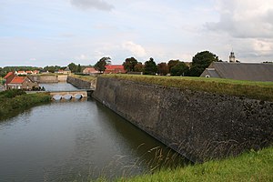 , The moat, the drawbridge, the western walls and the bastion of the Mill seen from the bastion of the Castle on Gravelines, France.