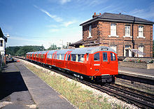 Red 1960 stock train heading for Ongar calls at North Weald, April 1990. This train comprises 2x 1960 DM and 1x 1938 T. 1960-Red-North-Weald.jpg