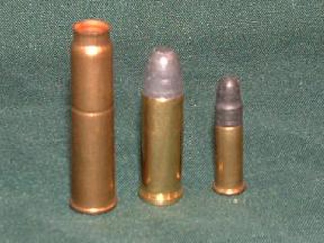 7.62×38mmR (7.62 mm Nagant) cartridge, left, shown next to a .32 S&W Long Cartridge (middle) and a .22 LR cartridge (right) for comparison.