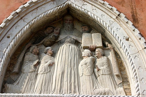 Saint Augustine surrounded by Augustinian monks (Paduan school, 15th century), relief in the portal tympanum of the former Augustinian convent of Sant