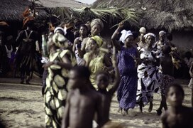 Ceremonial Grebo War Dances. Women in colourful lappa cloth dresses.