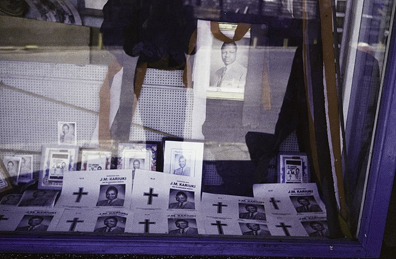 File:ASC Leiden - Rietveld Collection - East Africa 1975 - 05 - 009-mirror-small - Mourning shop window display and notice with a portrait and a cross for politician Josiah Mwangi Kariuki, murdered in 1975 (mirrored again) - Nairobi, Kenya.jpg