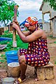 A Dagomba woman pounding cassava to prepare food