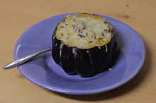 An acorn squash stuffed with pilaf and topped with cheese Acorn squash stuffed with pilaf and topped with cheese.jpg