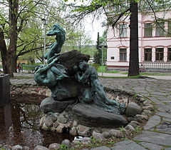The fountain from the side (Aino is attempting to resist the call of the three water maidens of Vellamo, while a man of Ahtola is pushing the rock from behind[11])