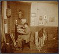 Allison seated indoors at her desk, holding a letter, ca. 1912-1920. (9561454163).jpg