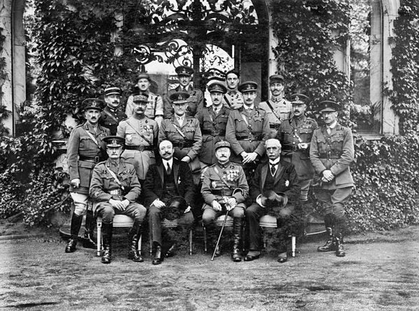Formal group photograph of British and French officers and commissioners outside the house of the Commander-in-Chief Allied Armies of Occupation, Mari