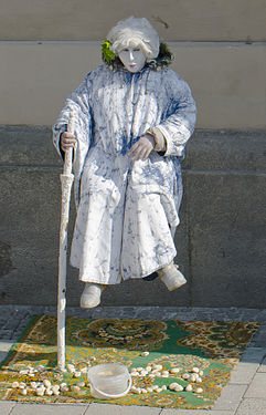 Street artist next to the entrance of the church of the Holy Spirit, Munich, Germany