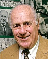 Red Auerbach speaking at an award ceremony.