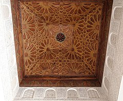 Example of carved cedar wood ceiling with geometric star patterns (over the madrasa's vestibule)