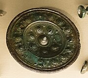 A bronze phalera found in Hořovičky with an inner circle of leaf-crowned faces, National Museum (Prague).[7]: 122 