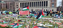 A scene of the reinstated campus encampment on April 21, 2024, several days after the NYPD arrested students and removed the first encampment. Columbia reinstated Gaza Solidarity Encampment Palestinian flags.jpg