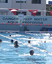 The heritage-listed "Aqua Profonda" sign at the Fitzroy baths, which many of the characters in Monkey Grip frequent during the hot summer days. Fitzroy Pool.jpg