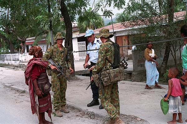 Australian Army and Australian Federal Police personnel of the International Force for East Timor (INTERFET) talk with a citizen in Dili, East Timor i