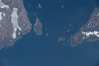 View of islands in Lake Huron between Manitoulin Island (left) and the northwestern tip of the Bruce Peninsula (right). North is oriented towards the upper left in this photo taken from the International Space Station on April 10, 2022. The largest island completely shown is Fitzwilliam Island on the left side.