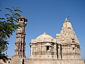 Kirti Stambha and a nearby temple.jpg