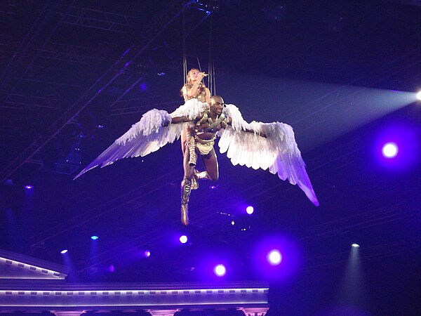 Minogue flying to the B-stage performing "Closer" atop of a dancer.