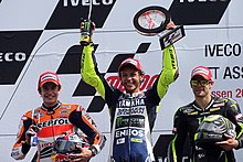 Marc Marquez, Valentino Rossi and Cal Crutchlow, celebrating on the podium. Rossi won the race, Marquez finished second and Crutchlow third. Marc Marquez, Valentino Rossi and Cal Crutchlow 2013 Assen 4.jpg