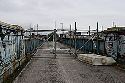 Scaffolding blocking off the exposed road surface of the long-defunct Sculcoates Bridge in Kingston upon Hull.