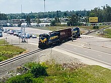 Local freight train crossing Alico Road near the Baker Spur junction south of Fort Myers Seminole Gulf Freight Train.jpg