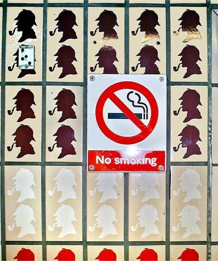 A "No smoking" sign surrounded by images of a smoking Sherlock Holmes at Baker Street tube station
