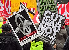 The now-familiar peace symbol was originally the Campaign for Nuclear Disarmament logo. Stop Trident CND Demo February 27 2016 001 Marble Arch (3) (24705925224).jpg