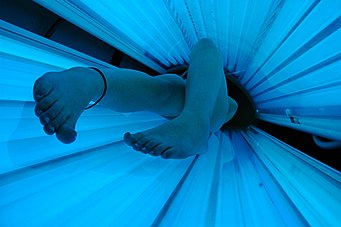 sun bed tanning Tanning bed in use.jpg