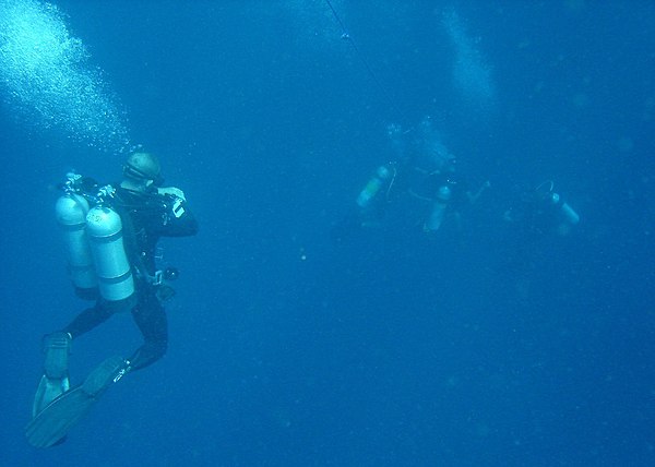 Divers decompressing in the water at the end of a dive
