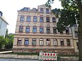 Apartment building in semi-open development with a front garden