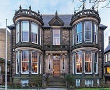 Double-fronted Victorian stone villa with large bay windows