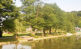 Tivoli Pond after the 2011 renovation. Two wooden staircases have been added to the west side. The Tivoli Greenhouse and the Tivoli Rose Garden are visible in the back.