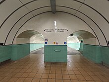 Two arched openings lead to two sloping tunnels, heading underneath the Tyne. The lower half of the walls are tiled green, the upper half with white and the floor a dark orange.