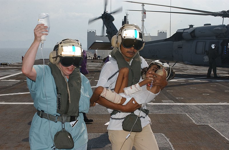 File:US Navy 050222-N-6665R-038 A nurse from Project Hope carries an IV bag while an Indonesian man carries his boy from a MH-60S Seahawk helicopter after arriving aboard the Military Sealift Command (MSC) hospital ship USNS Mercy (.jpg