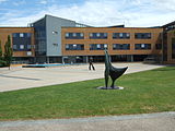 The School of Management Building with the statue of Alan Turing in the middle distance.