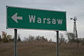 Sign on MN HWY 60 indicating turn-off to Warsaw
