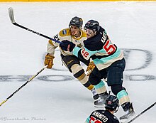 Howden (left) battling for position against Tye Kartye of the Seattle Kraken during the 2024 Winter Classic. Winter Classic - Vegas Golden Knights at Seattle Kraken - January 1, 2024 - Tye Kartye and Brett Howden (53439910017).jpg