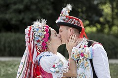 Kissing couple in traditional Kobylí costumes